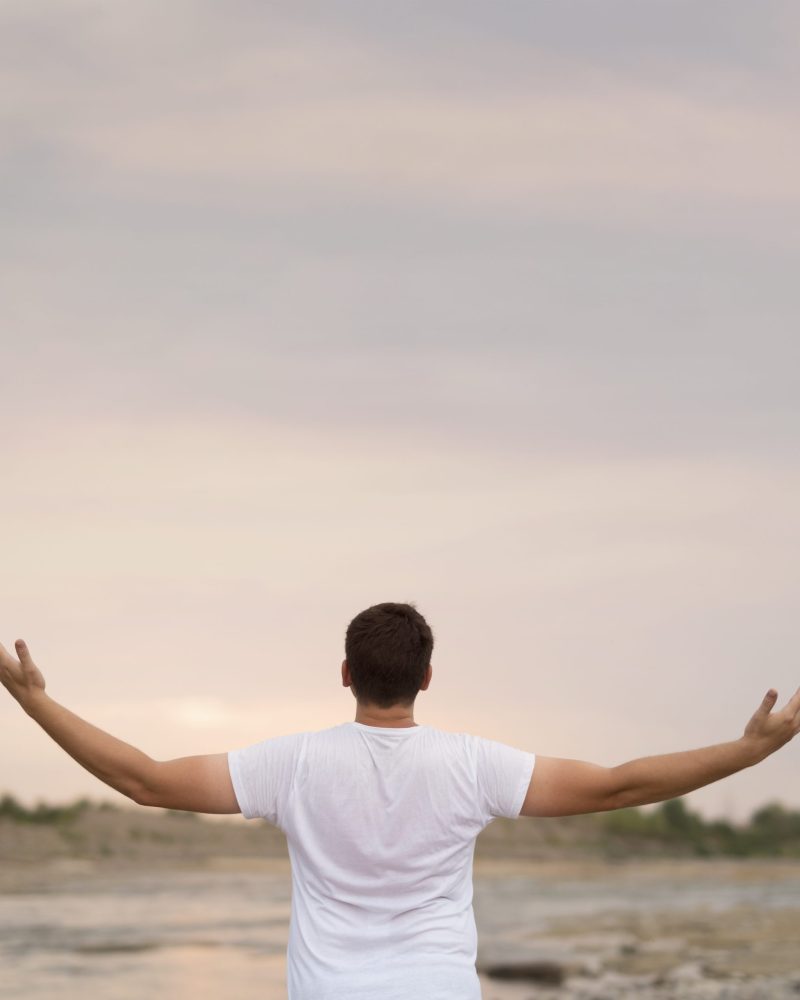 young-man-with-his-arms-air